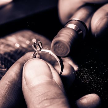 Craft jewelery making. Ring polishing. Macro shot. Monochrome cream tone. Black and white photography.